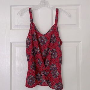Pattern tank with a knot tie in front.